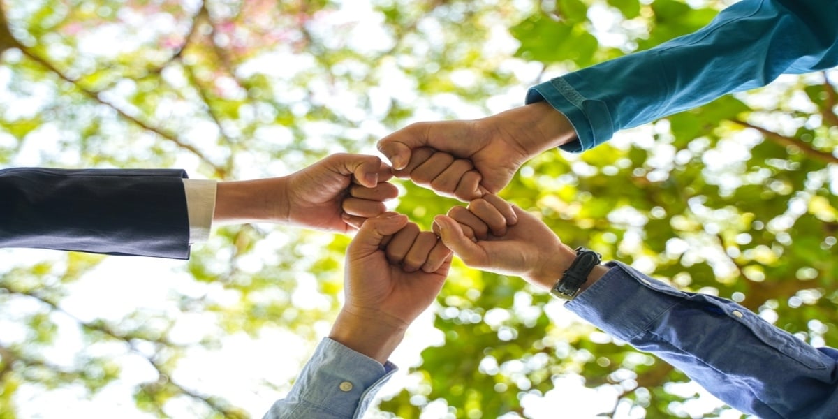  A group of people fist bumping